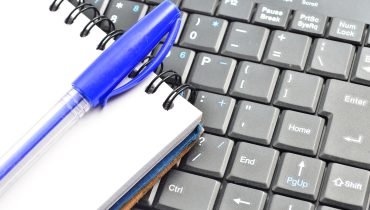 A notepad and keyboard of a computer. write down and save
