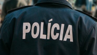 View from the back of a Portuguese policeman guards public order