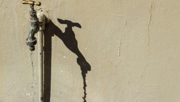 Faucet with water dripping down at daytime