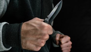 Close-up of an attacker with a knife in his hand