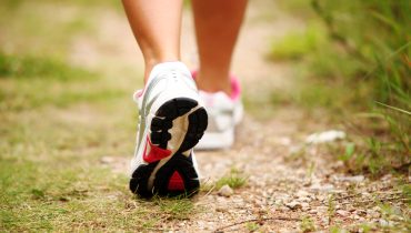 Female legs jogging on a trail