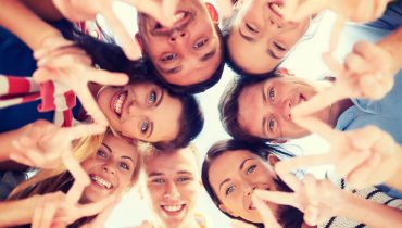 group of teenagers showing finger five gesture