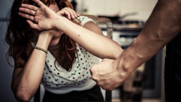 Woman covering her face in fear of domestic violence